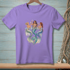 Three mermaids with champagne glasses in water, on a lavender t-shirt.