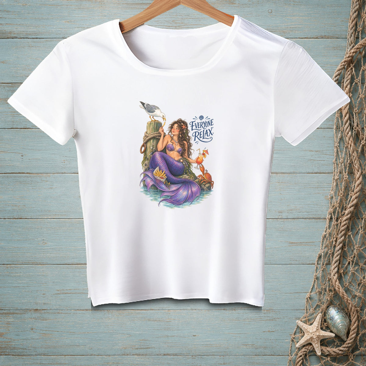 White t-shirt with mermaid, seagull, crab, fries, drink, and "Everyone Relax" text.