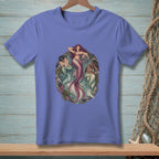 Three mermaids lounging in a rocky, aquatic environment with starfish and seaweed.