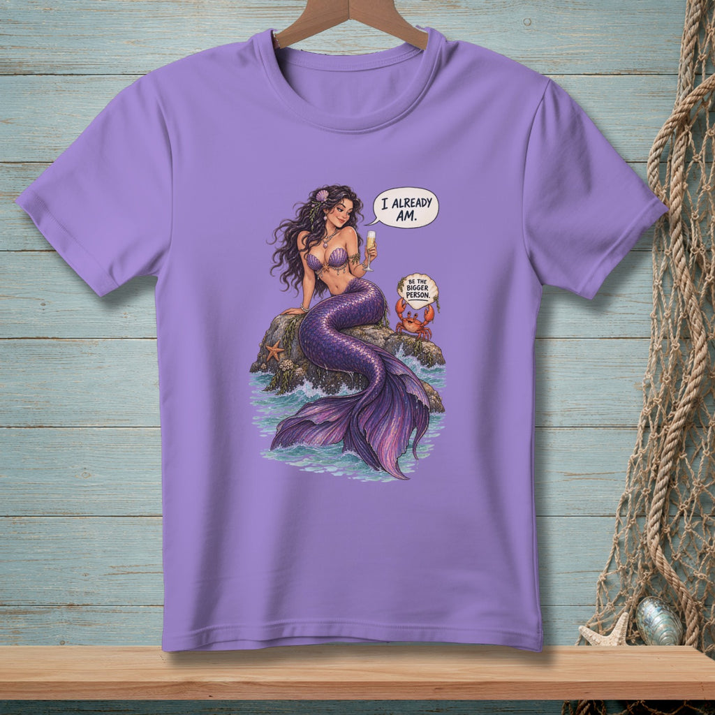 Purple t-shirt with mermaid sitting on a rock, saying "I already am" next to a crab.