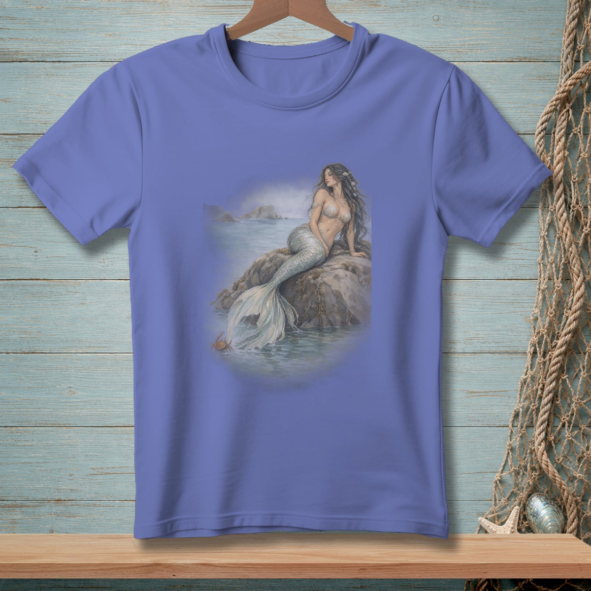 T-shirt with a mermaid sitting on a rock by the sea.