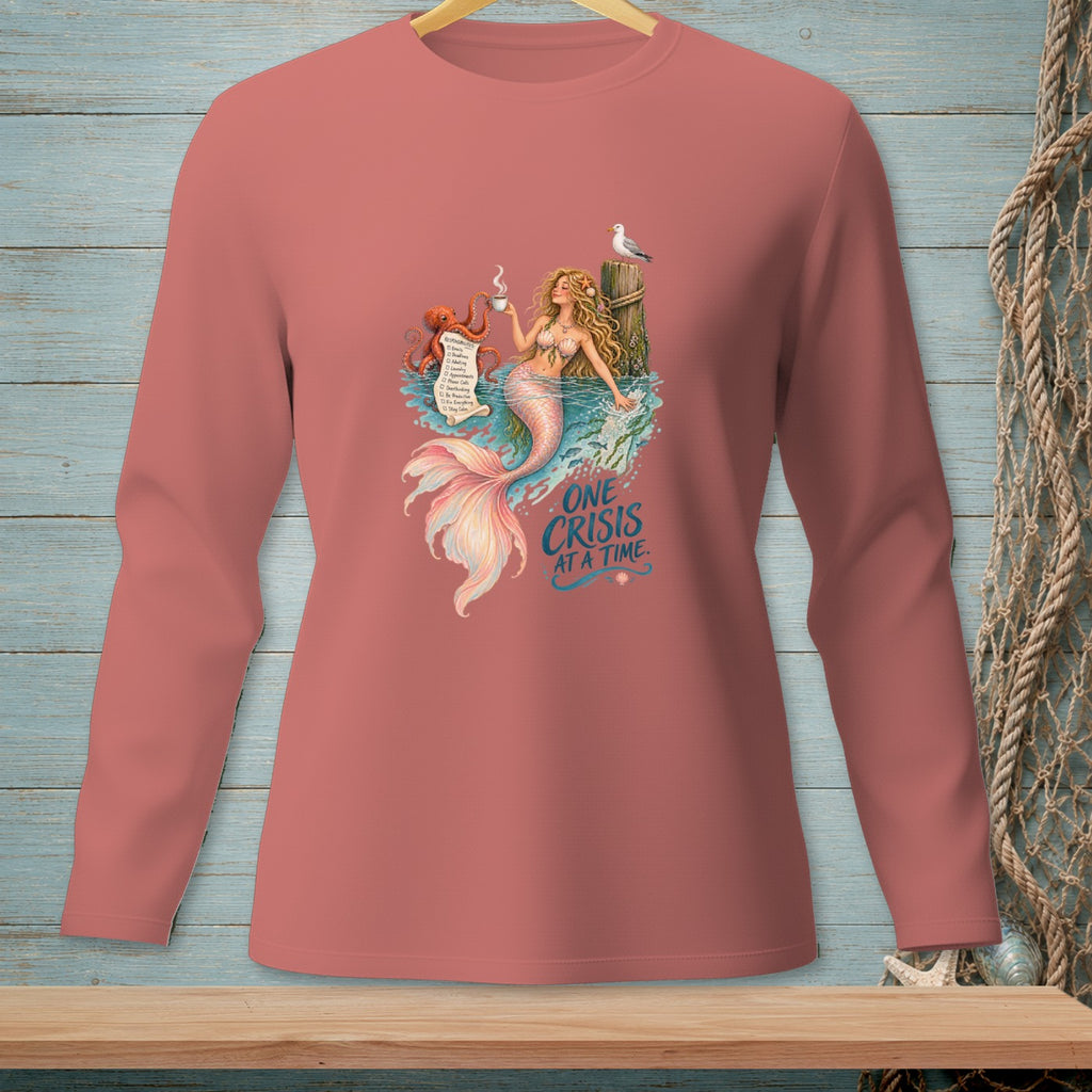 Mermaid holding coffee with octopus and list, text reads "ONE CRISIS AT A TIME."
