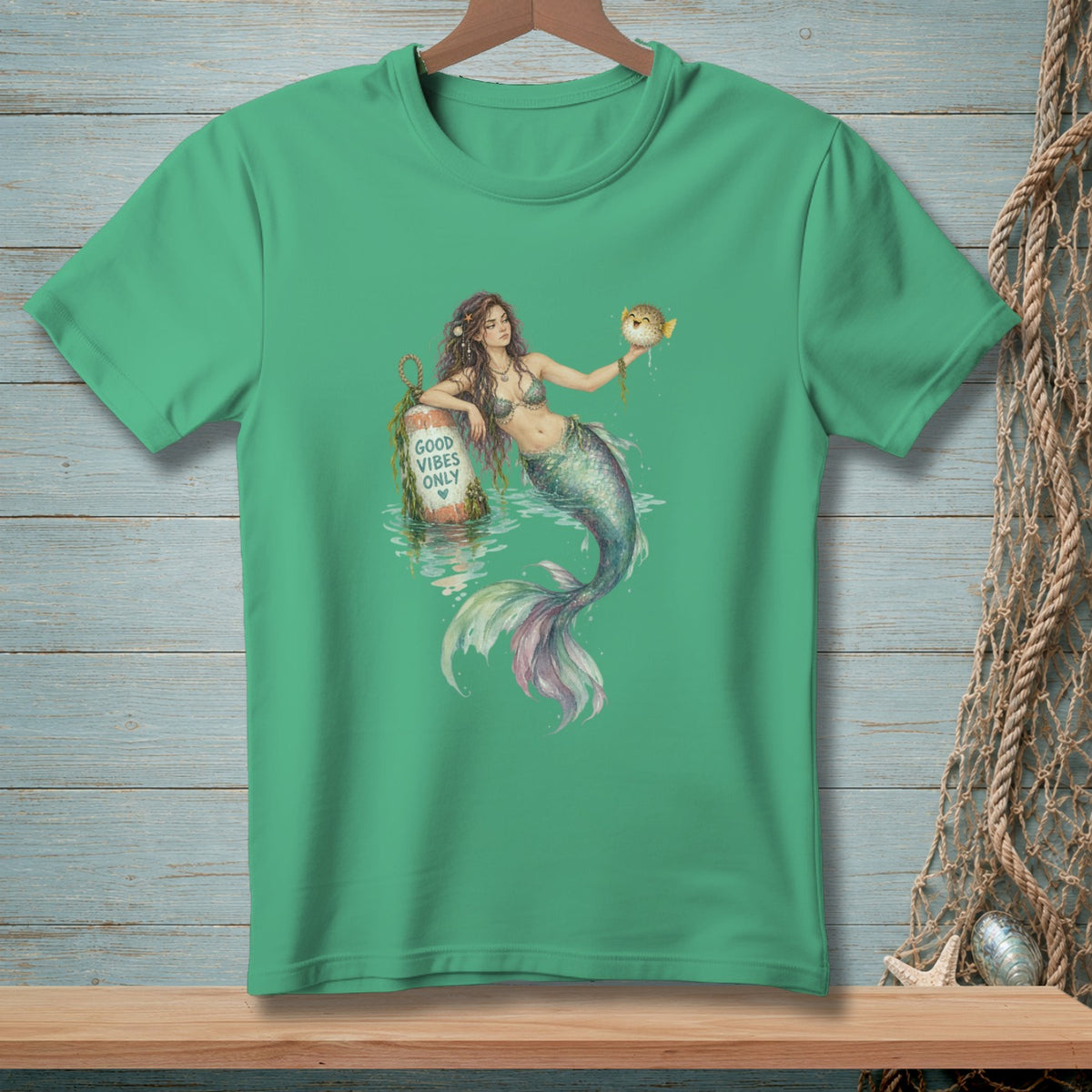 Mermaid holding a pufferfish near buoy with "Good Vibes Only" text.