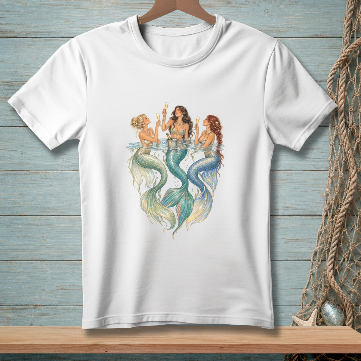Three mermaids with champagne glasses toast in the water.