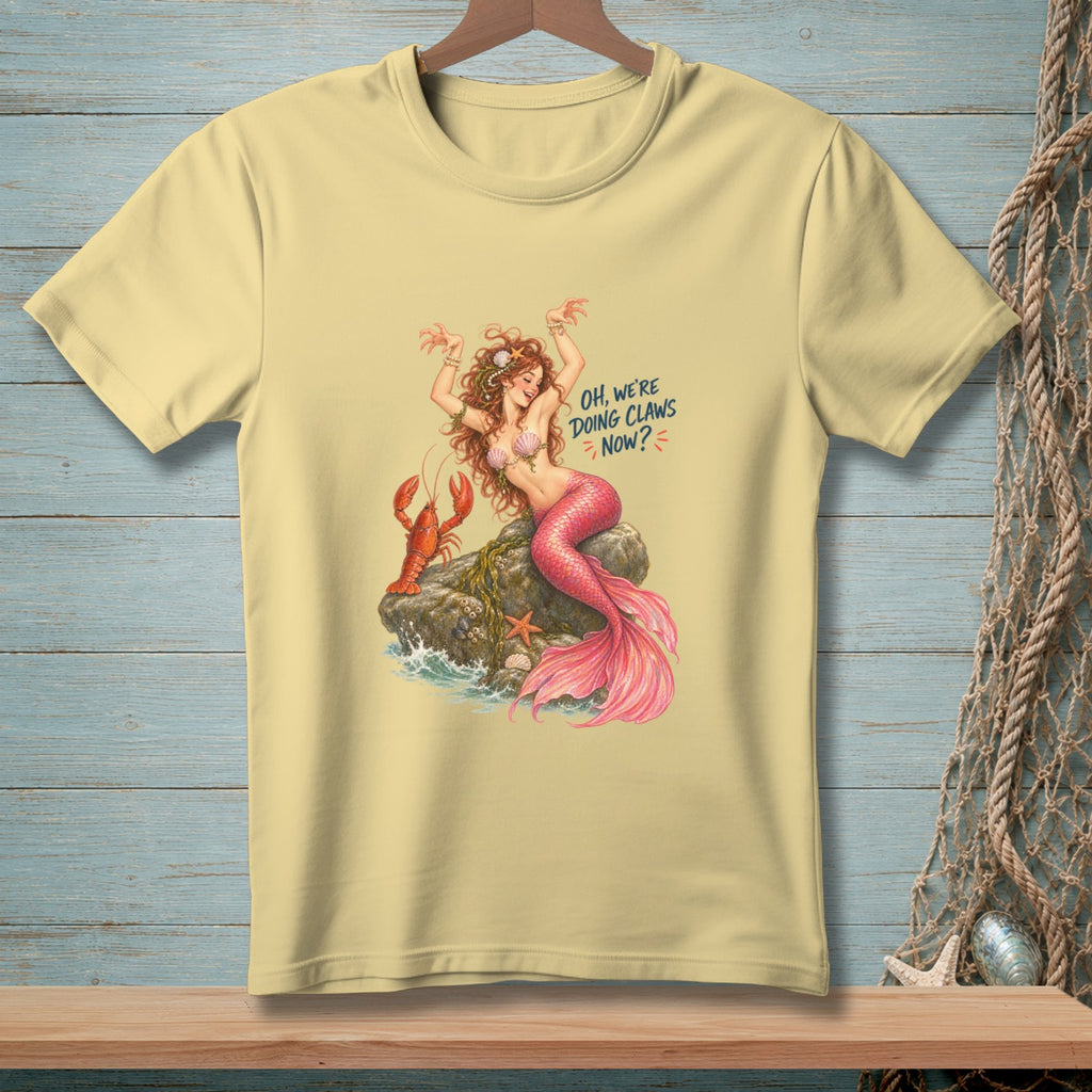 Yellow t-shirt with mermaid, lobster, and text "Oh, we're doing claws now?".