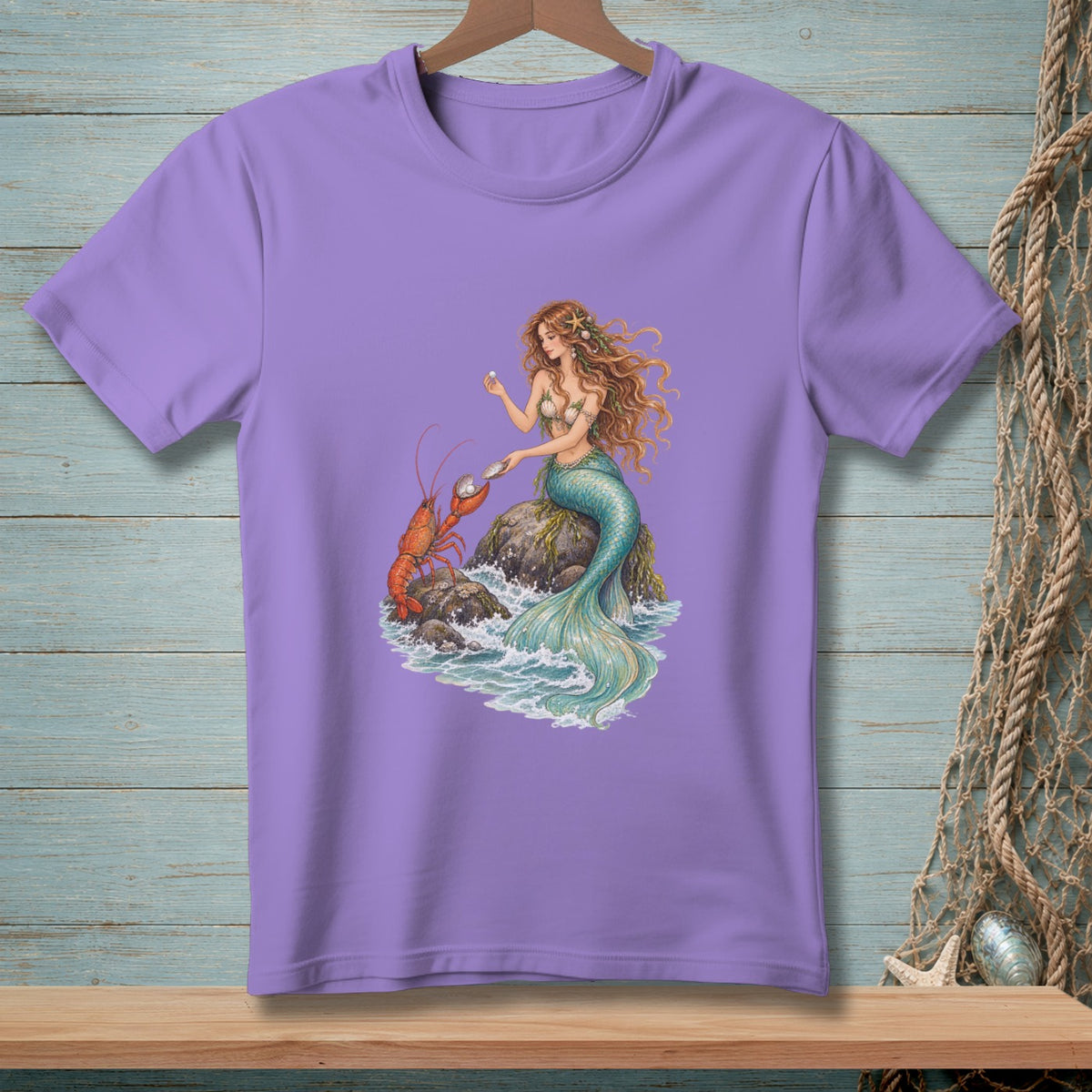 Purple t-shirt with a mermaid, lobster, and pearls on rocks in waves.