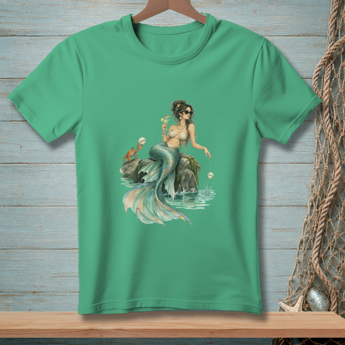 Mermaid with cocktail and crab on rock in ocean, printed on a green t-shirt.