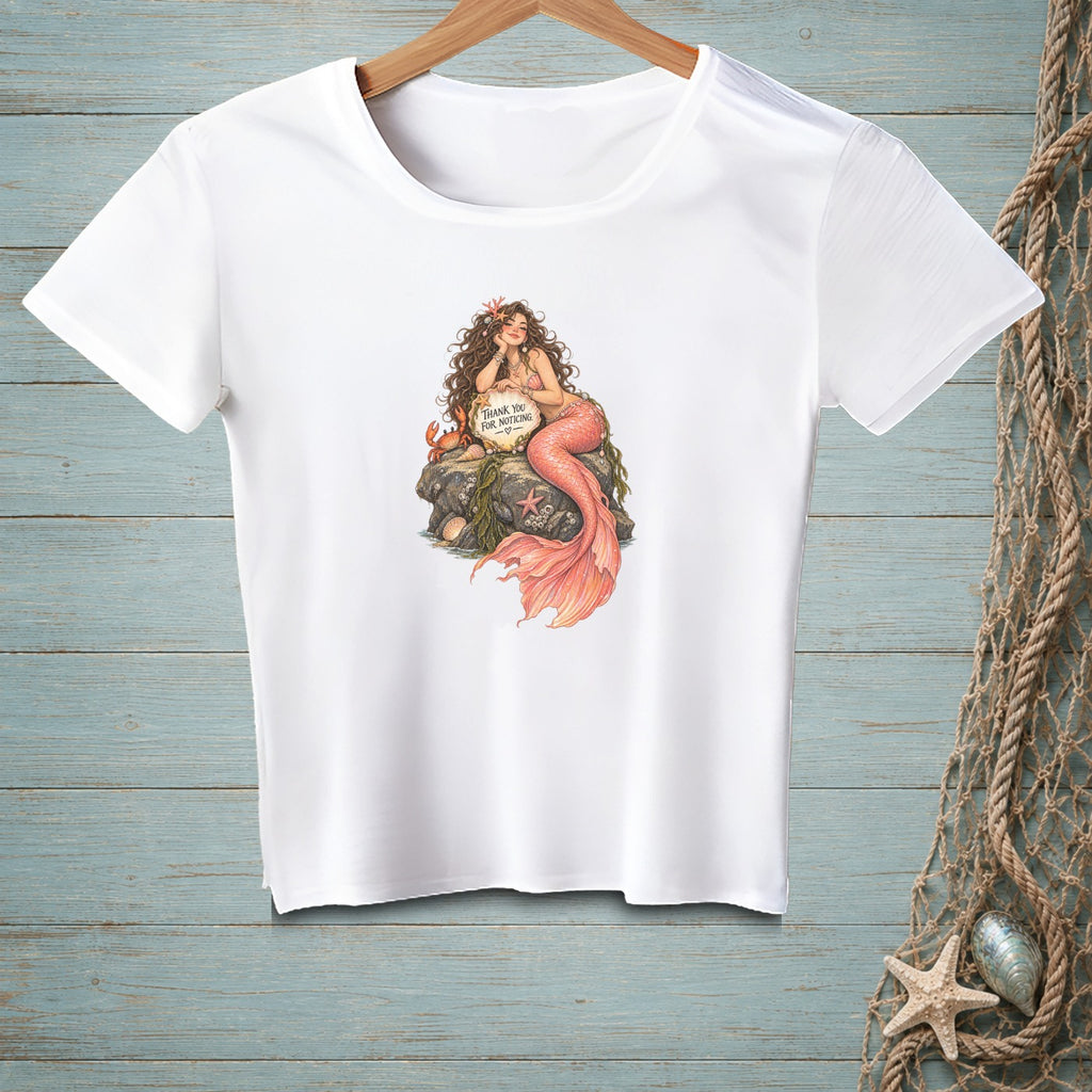 White t-shirt with mermaid illustration holding "Thank You For Noticing" sign.