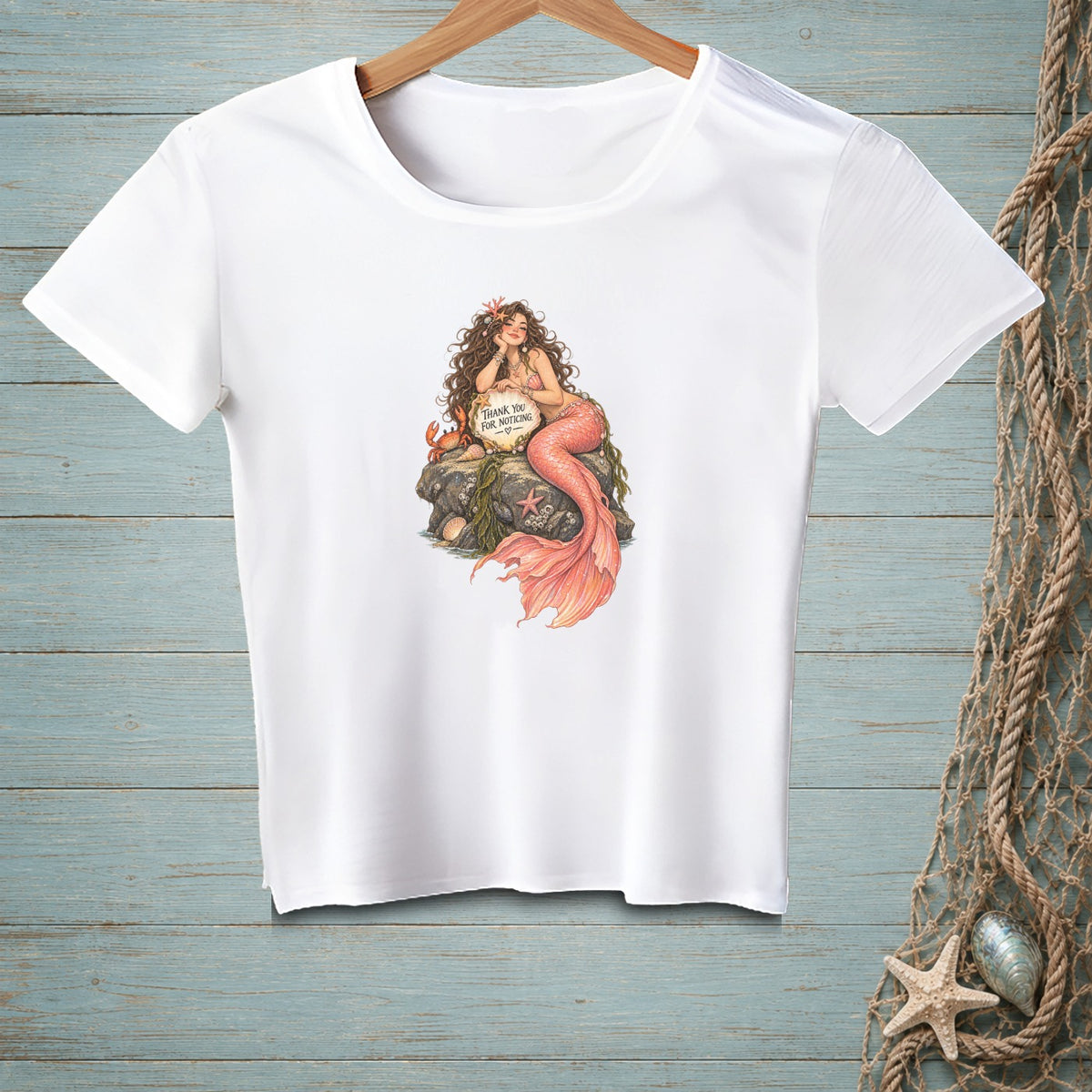 White t-shirt with mermaid illustration holding "Thank You For Noticing" sign.