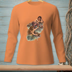 Orange long-sleeve shirt with a graphic of two mermaids on rocks near water.