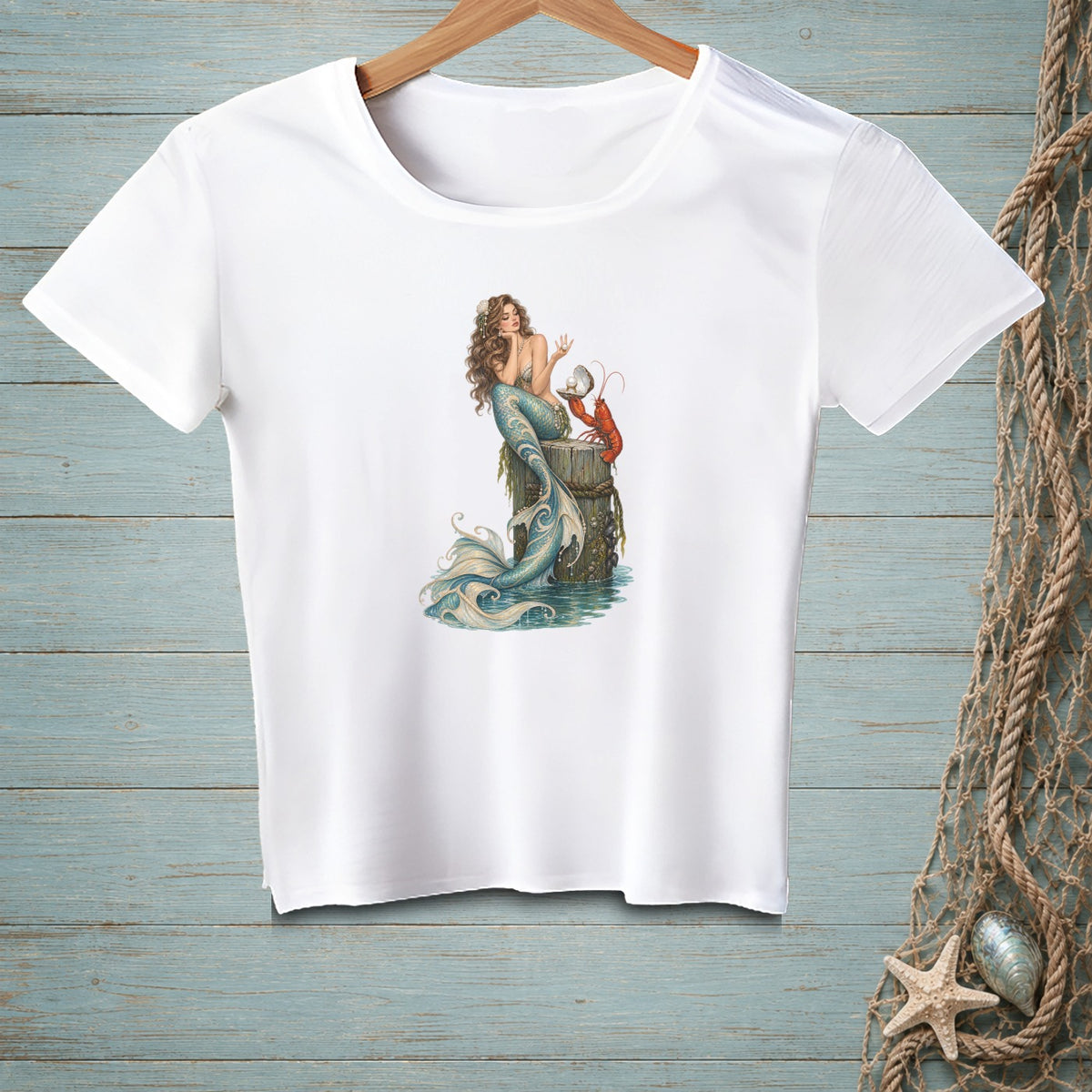 White t-shirt featuring a mermaid, lobster, and pearl on a wooden post.