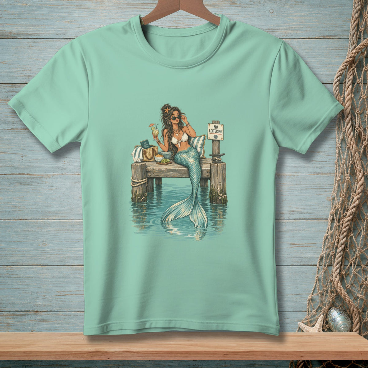 Mermaid on a dock with a drink and a "No Loitering" sign.