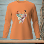 Two mermaids sharing cupcakes in a heart-shaped splash on an orange shirt.