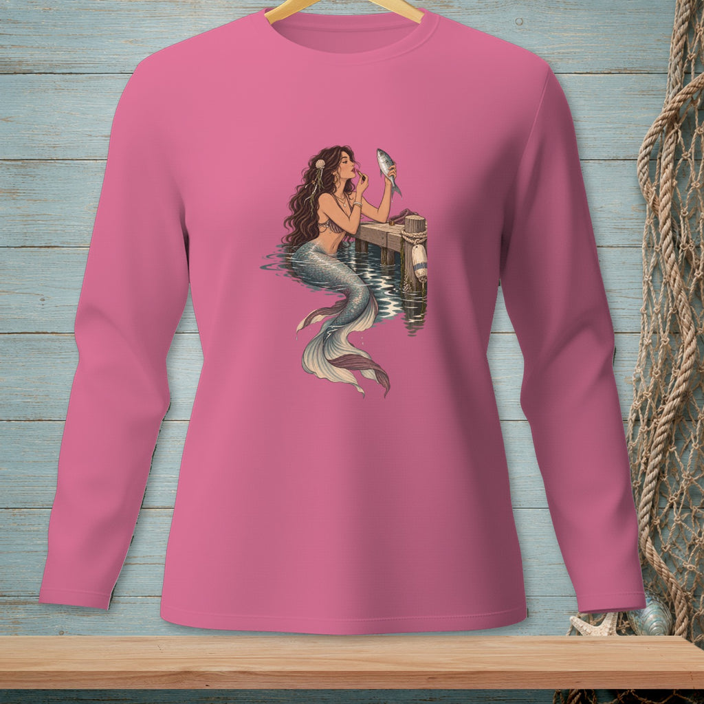 Pink long-sleeve shirt with a mermaid applying makeup with a fish.