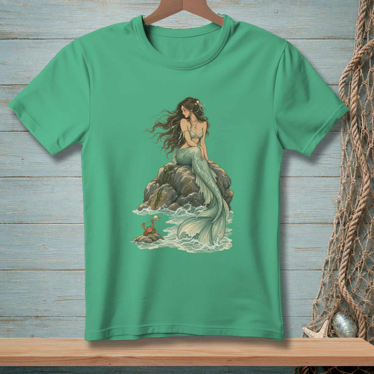 Mermaid sitting on rocks with a crab at her feet.
