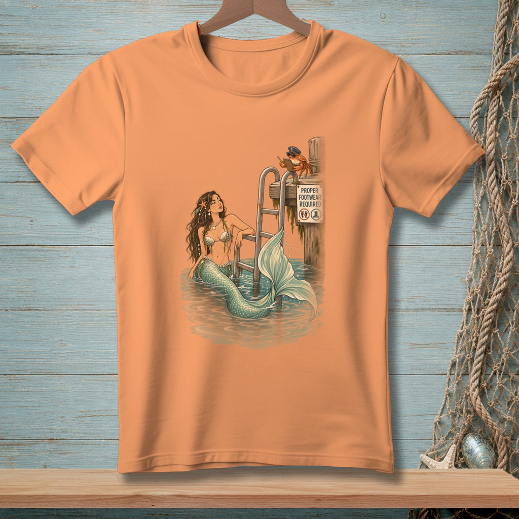 An orange crewneck t-shirt featuring a retro illustration of a mermaid in the water.