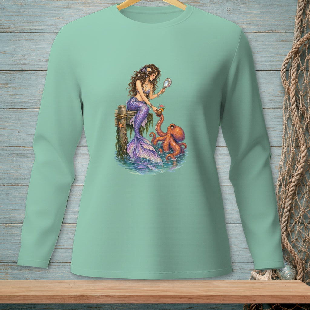 Mermaid with purple tail and octopus on dock, holding a mirror and a drink.