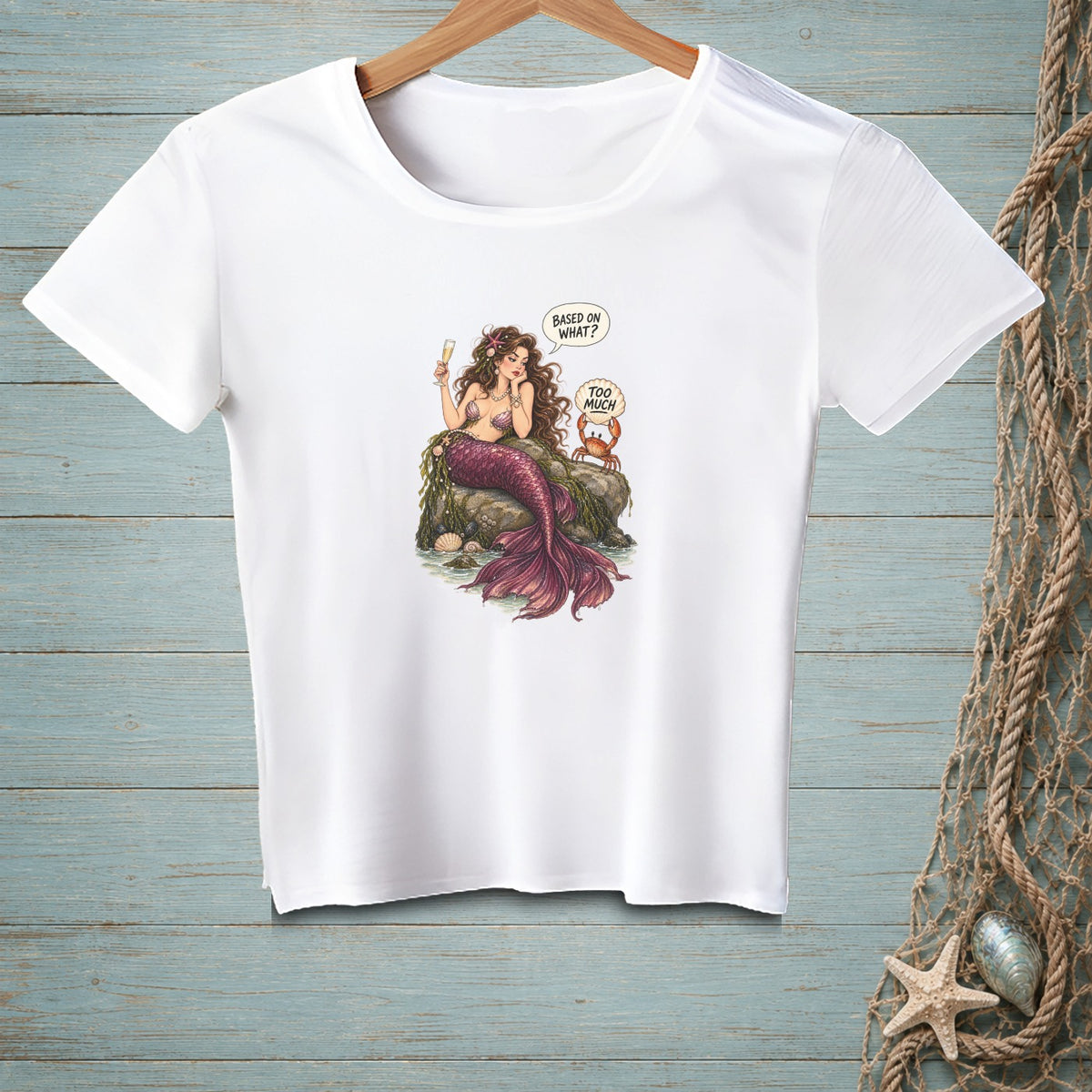 White t-shirt with mermaid sitting on rocks holding champagne, crab says "Too Much".