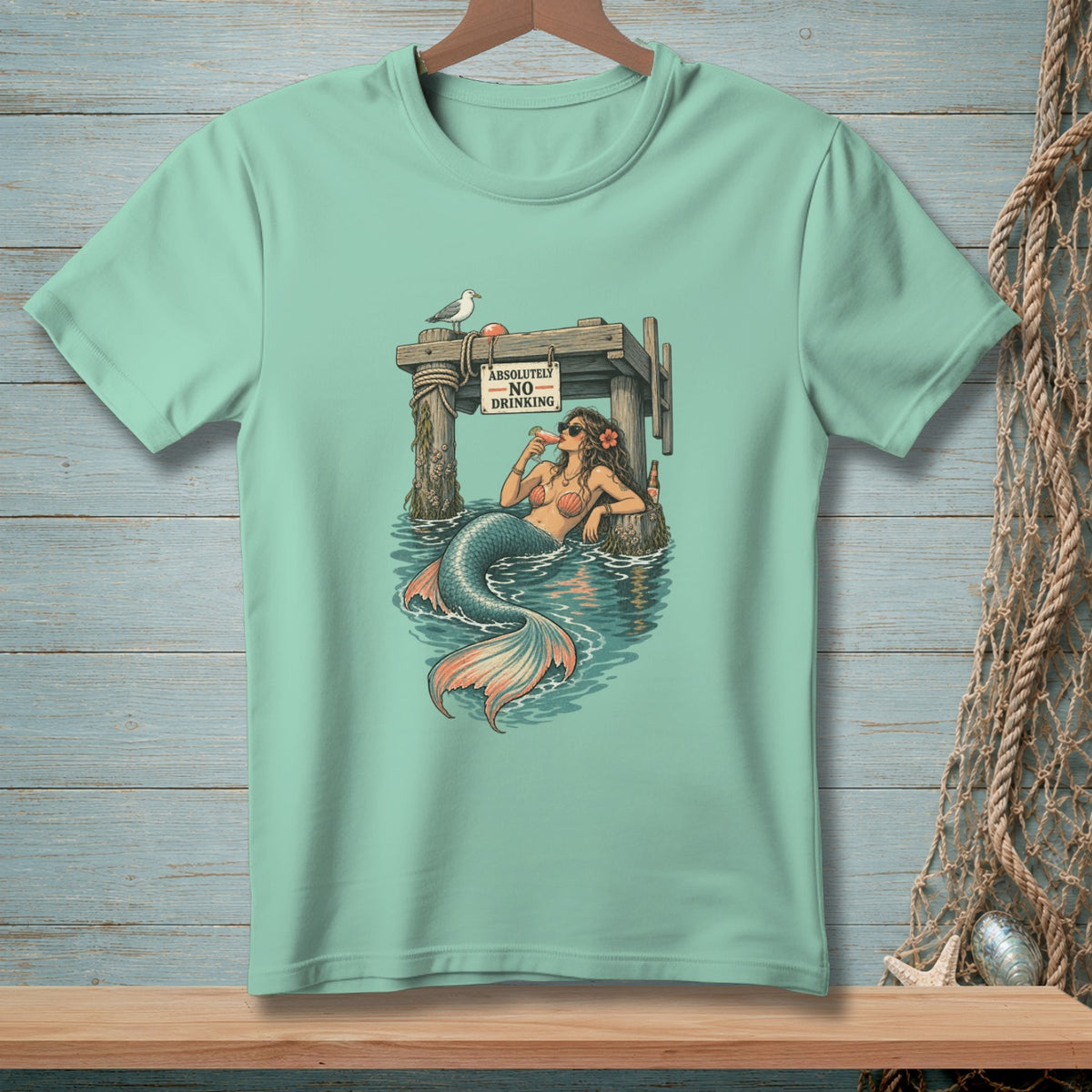 Mermaid on pier with a drink and sign reading "Absolutely No Drinking."