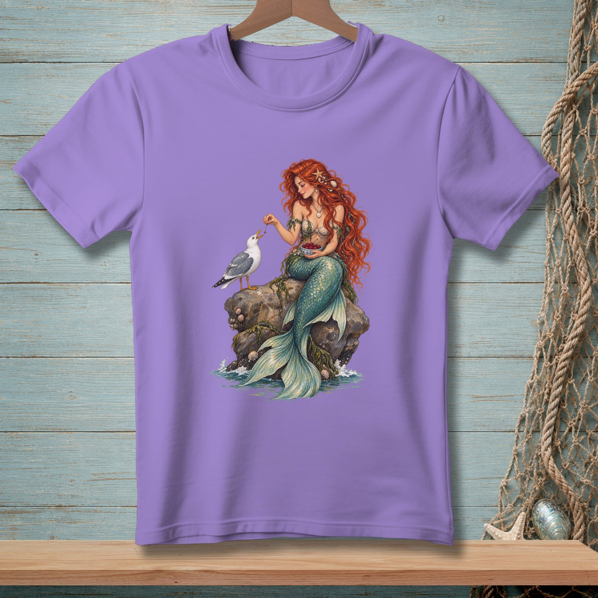Mermaid feeding a seagull on a rock with a bowl of berries.
