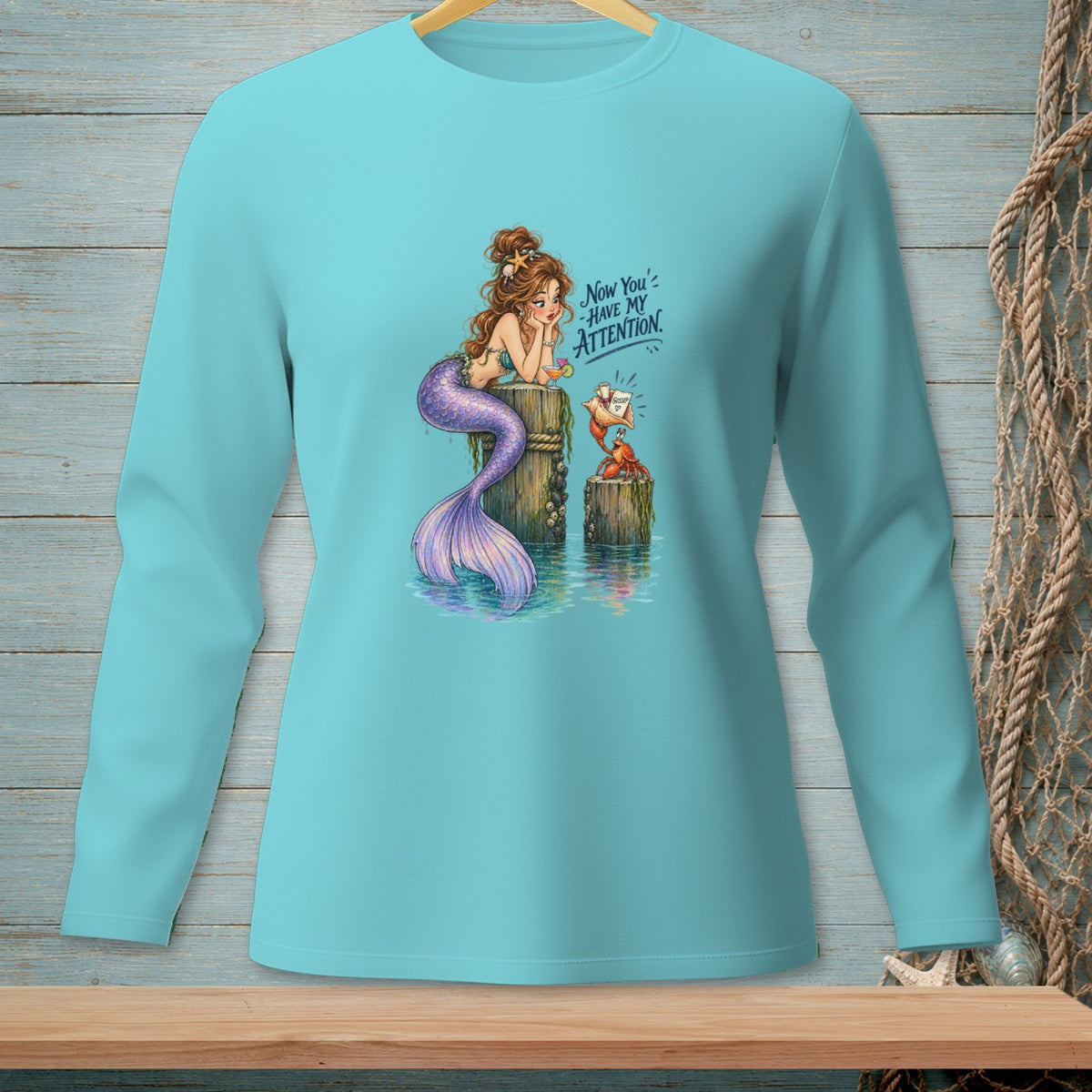 Mermaid sitting on a post, looking at a crab with a message, text says "Now You've Have My Attention."