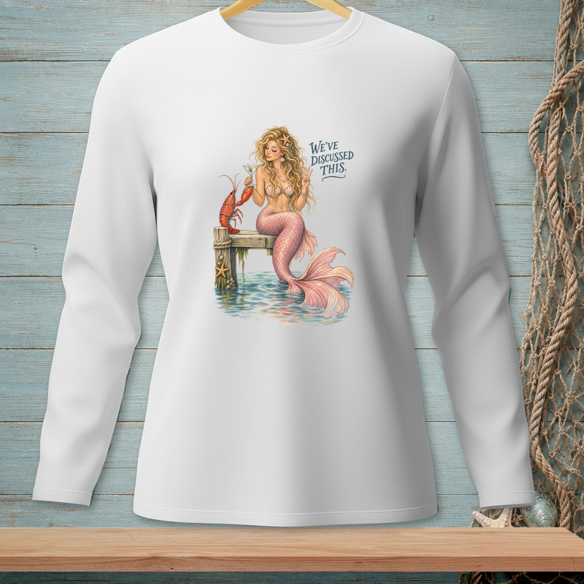 Mermaid with lobster and drink on dock, text "WE'VE DISCUSSED THIS."