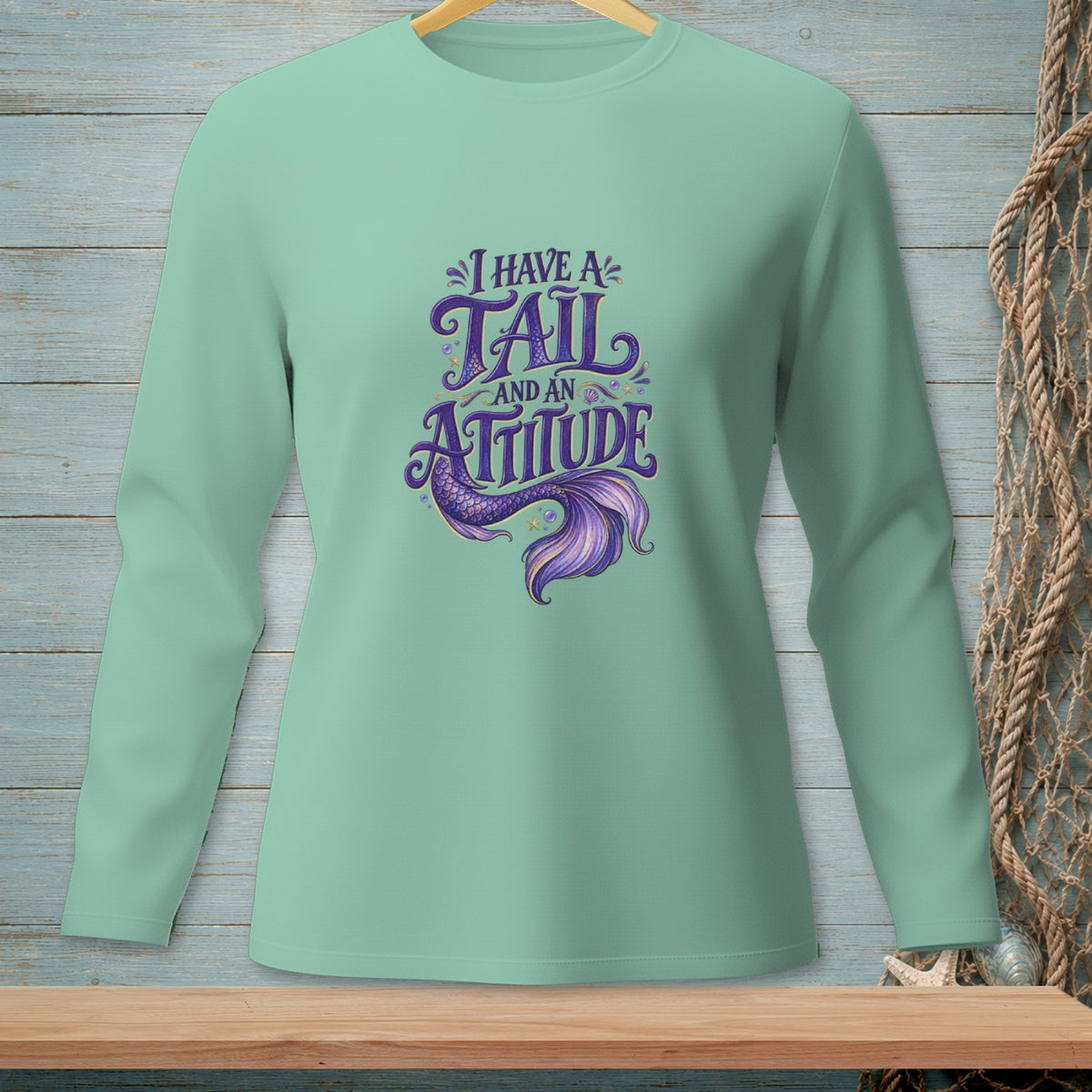 Mint green long-sleeve shirt with purple mermaid tail and "I HAVE A TAIL AND AN ATTITUDE" text.