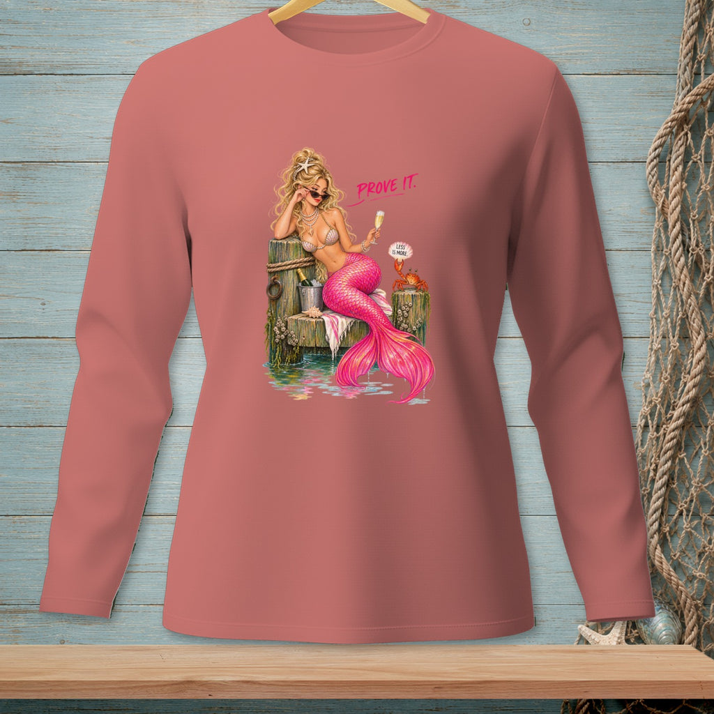 Mermaid with pink tail holding champagne, text "PROVE IT." and "LESS IS MORE."