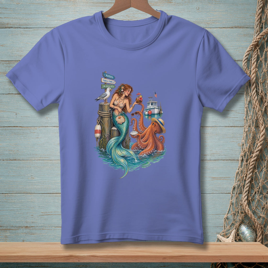 Mermaid, octopus, and seagull on a dock with signs for Marina, Tides & Tunes, Fresh Catch.