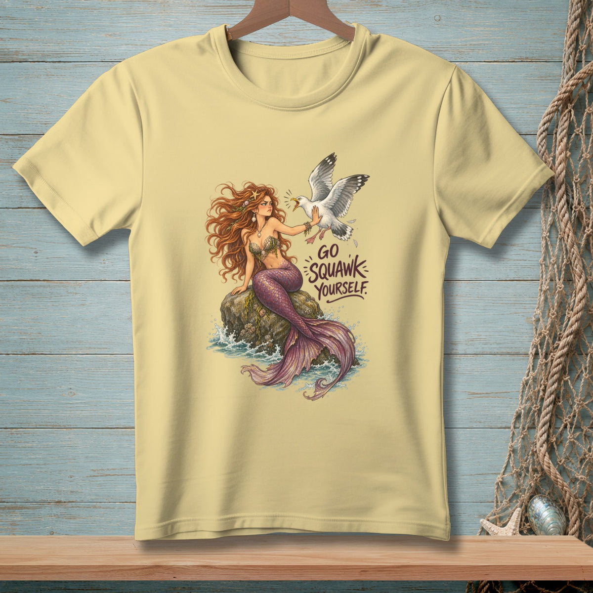 Yellow t-shirt with mermaid and seagull graphic and "Go Squawk Yourself" text.
