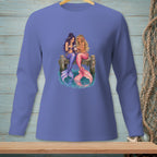 Two mermaids with colorful tails sit on a dock looking at a phone.