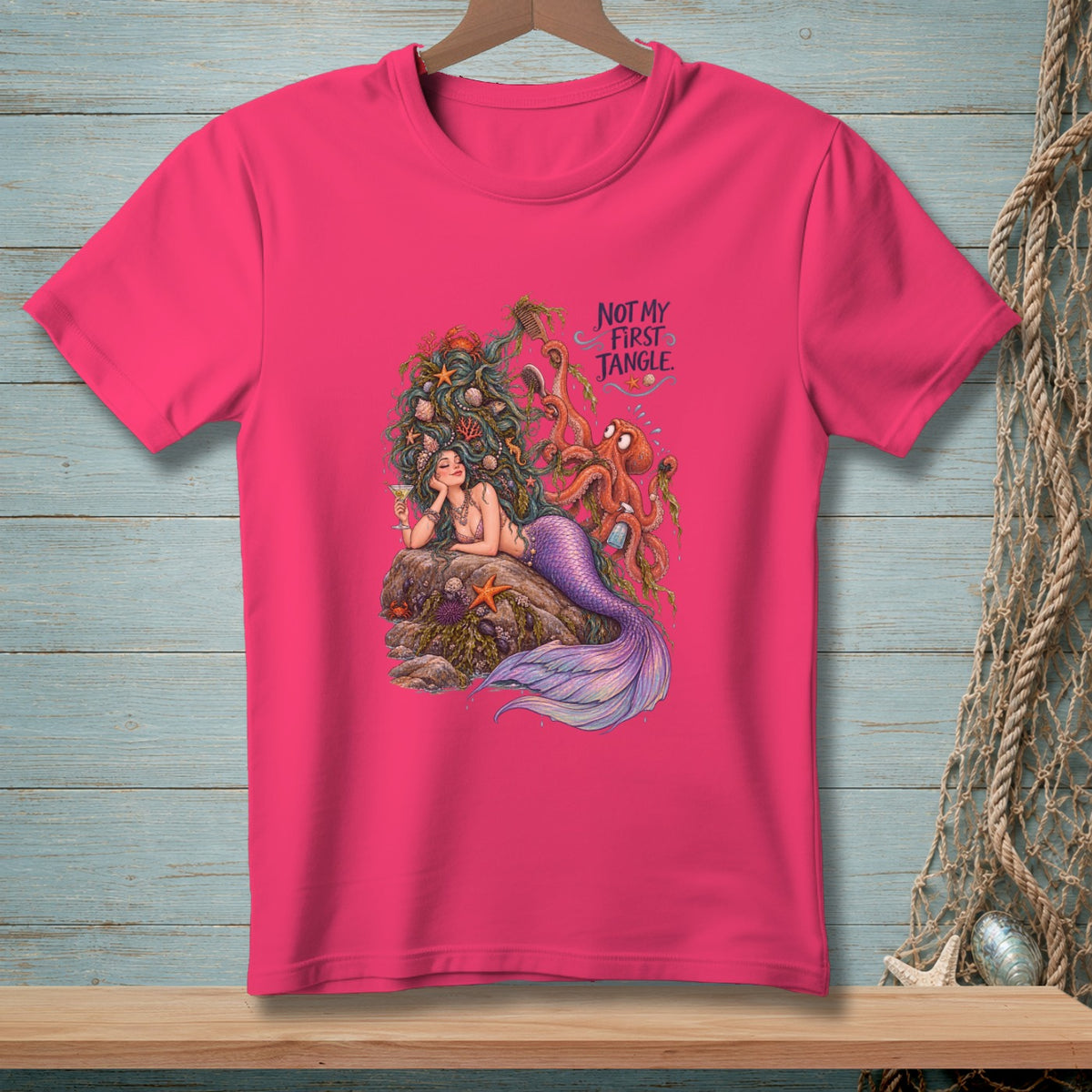 Pink t-shirt with mermaid, octopus, and text "Not My First Tangle".