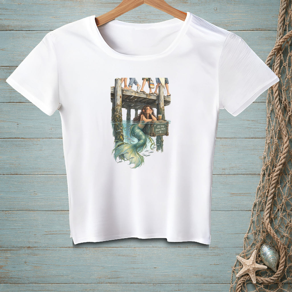 White t-shirt with a graphic of a mermaid on a dock, text reads "I'll stay down here."