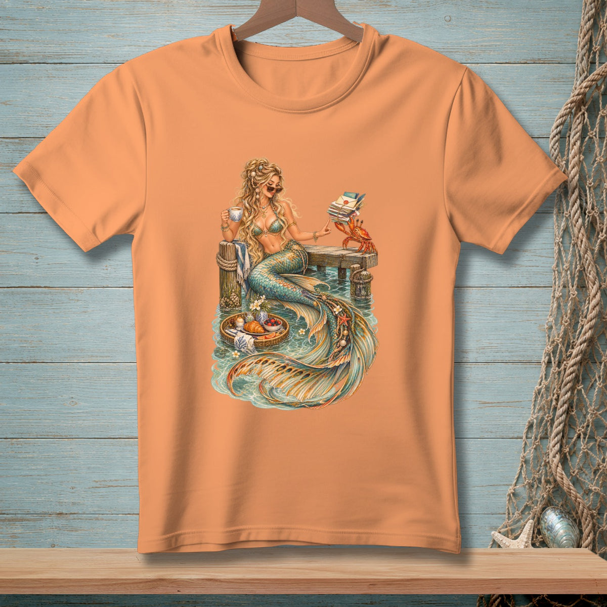 Mermaid sitting on a pier holding coffee and books with a crab and breakfast tray.