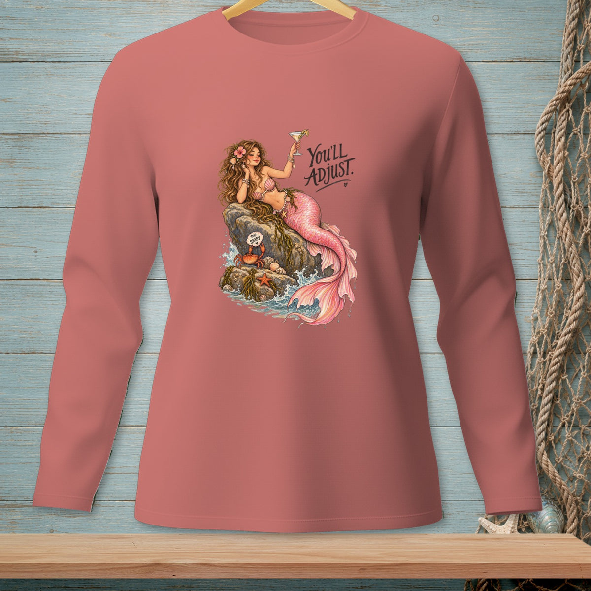 Sassy mermaid with cocktail on a rock, text reads "You'll ADJUST."