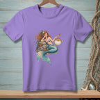 A light purple t-shirt featuring an illustration of a mermaid holding a drink next to a pufferfish.
