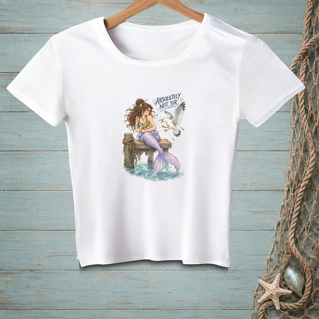 White t-shirt with a mermaid sitting on a dock, holding a burger, while a seagull approaches.
