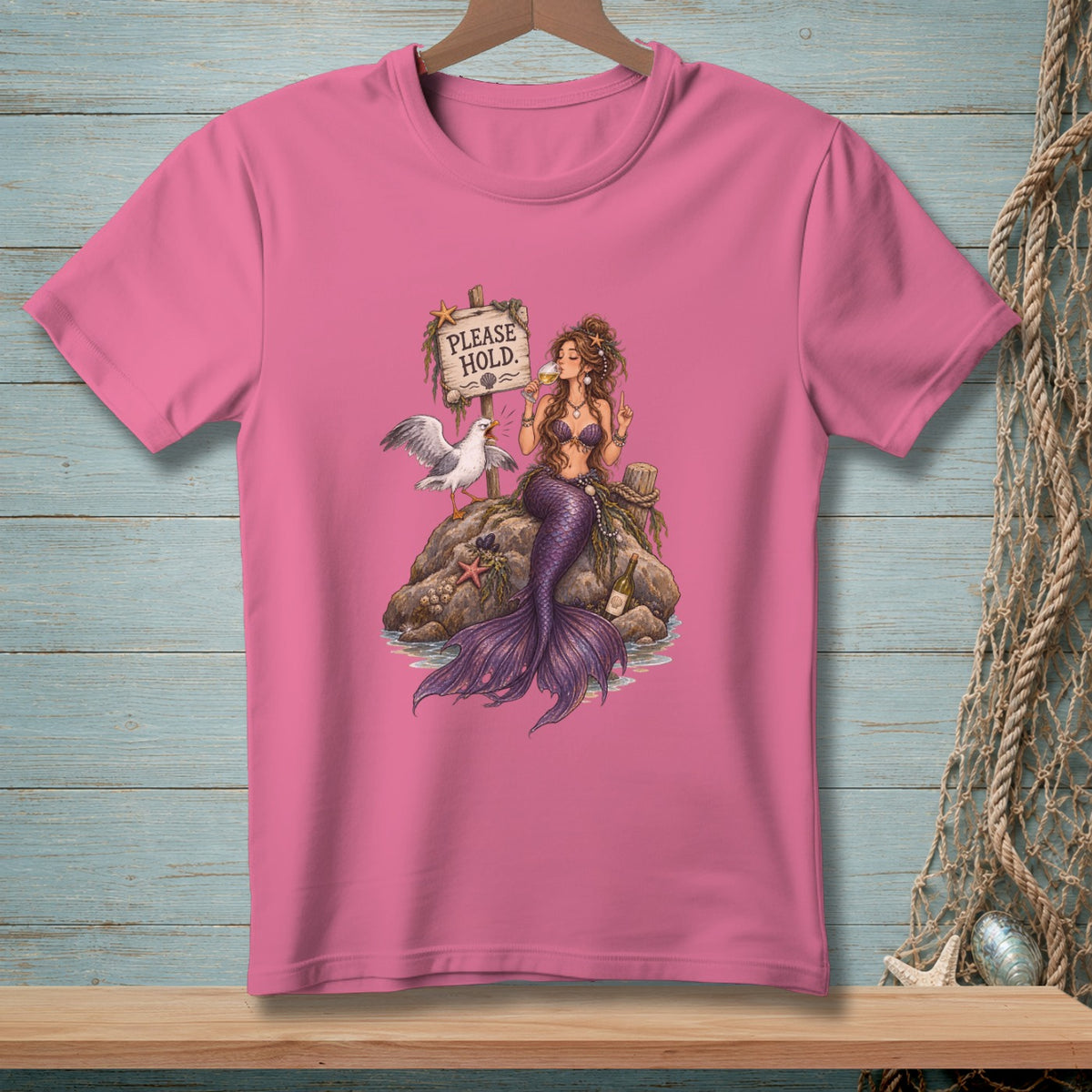 Mermaid drinks wine by a sign reading "PLEASE HOLD" with a seagull and starfish.
