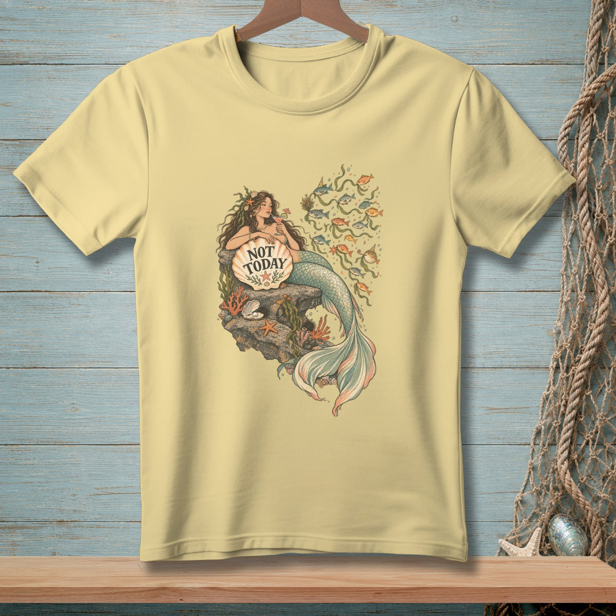 Light yellow t-shirt with a mermaid illustration holding a shell with "NOT TODAY" text.
