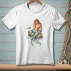 White t-shirt featuring a mermaid sitting on a rock with a seagull.