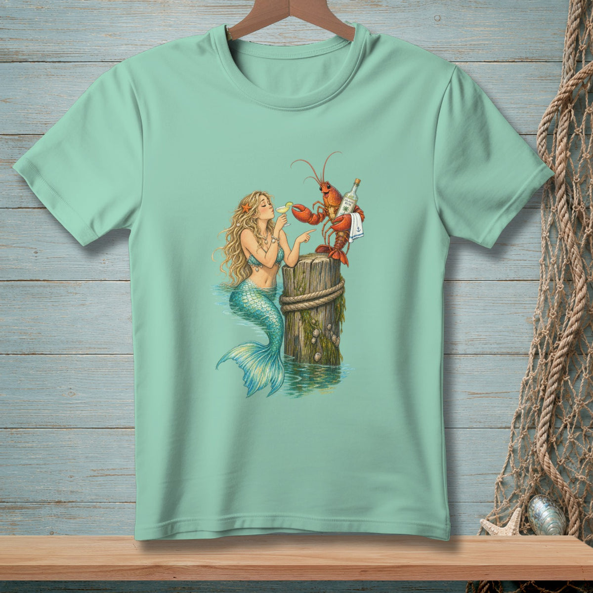 Mermaid and lobster on a post with drinks on a teal t-shirt.