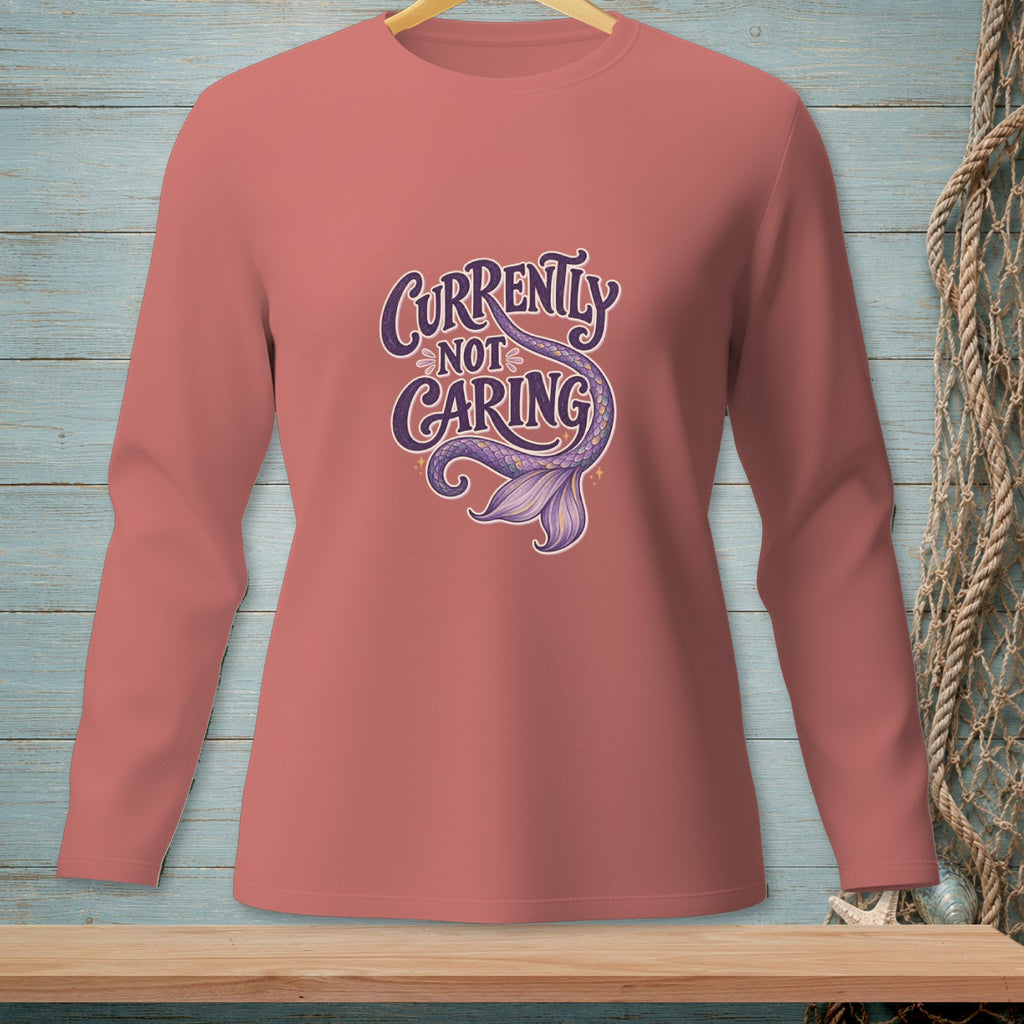 Long-sleeved coral shirt with "Currently Not Caring" and a purple mermaid tail graphic.