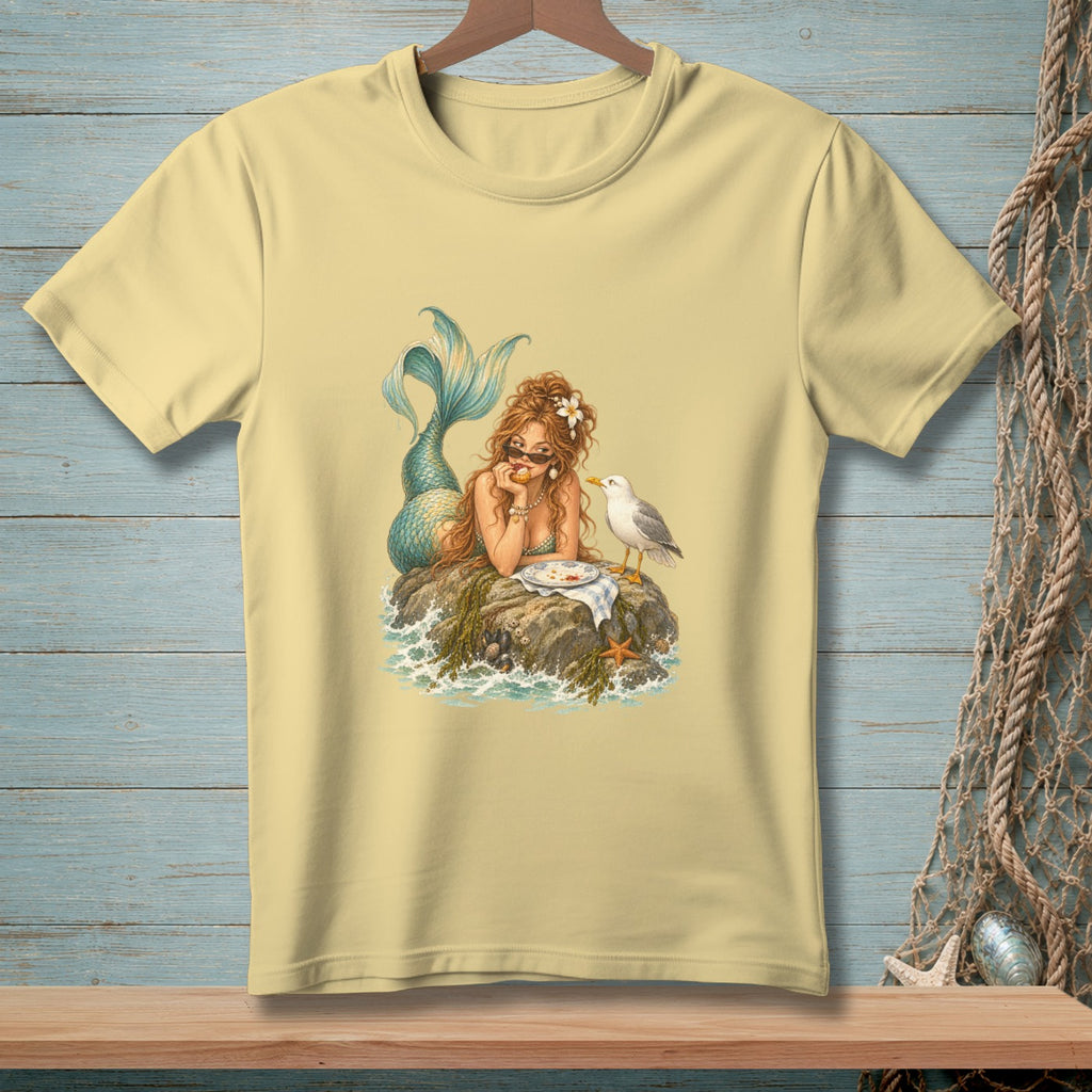 Illustration of a mermaid sitting on a rock with a seagull and a plate of food.