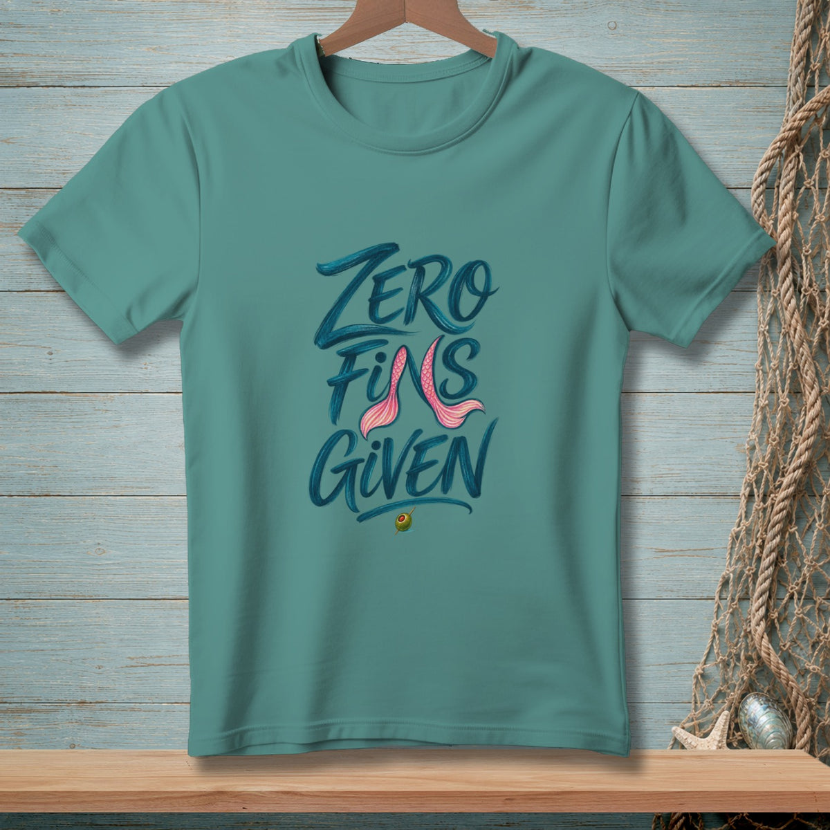 Teal t-shirt with "ZERO FINS GIVEN" text and pink mermaid tail graphic.