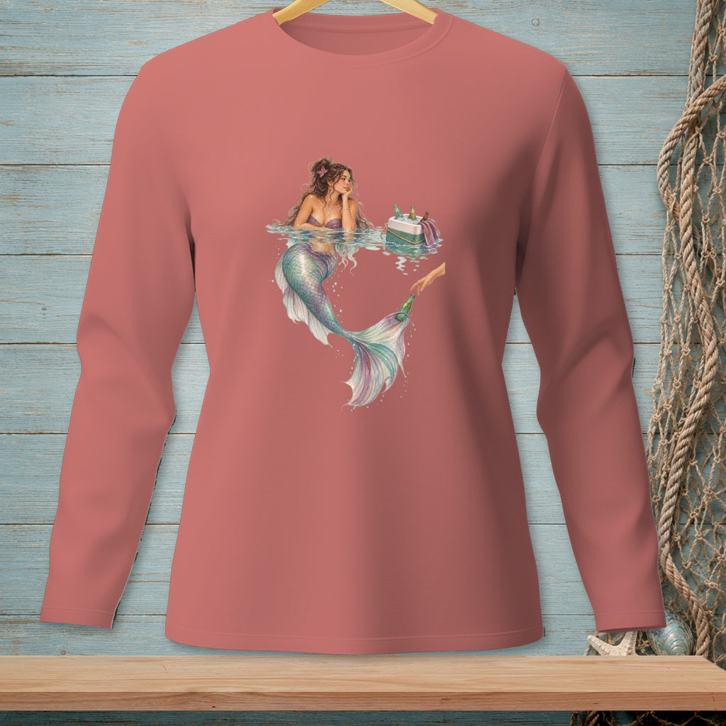 Mermaid with cake and a cooler of drinks on a pink long-sleeved shirt.
