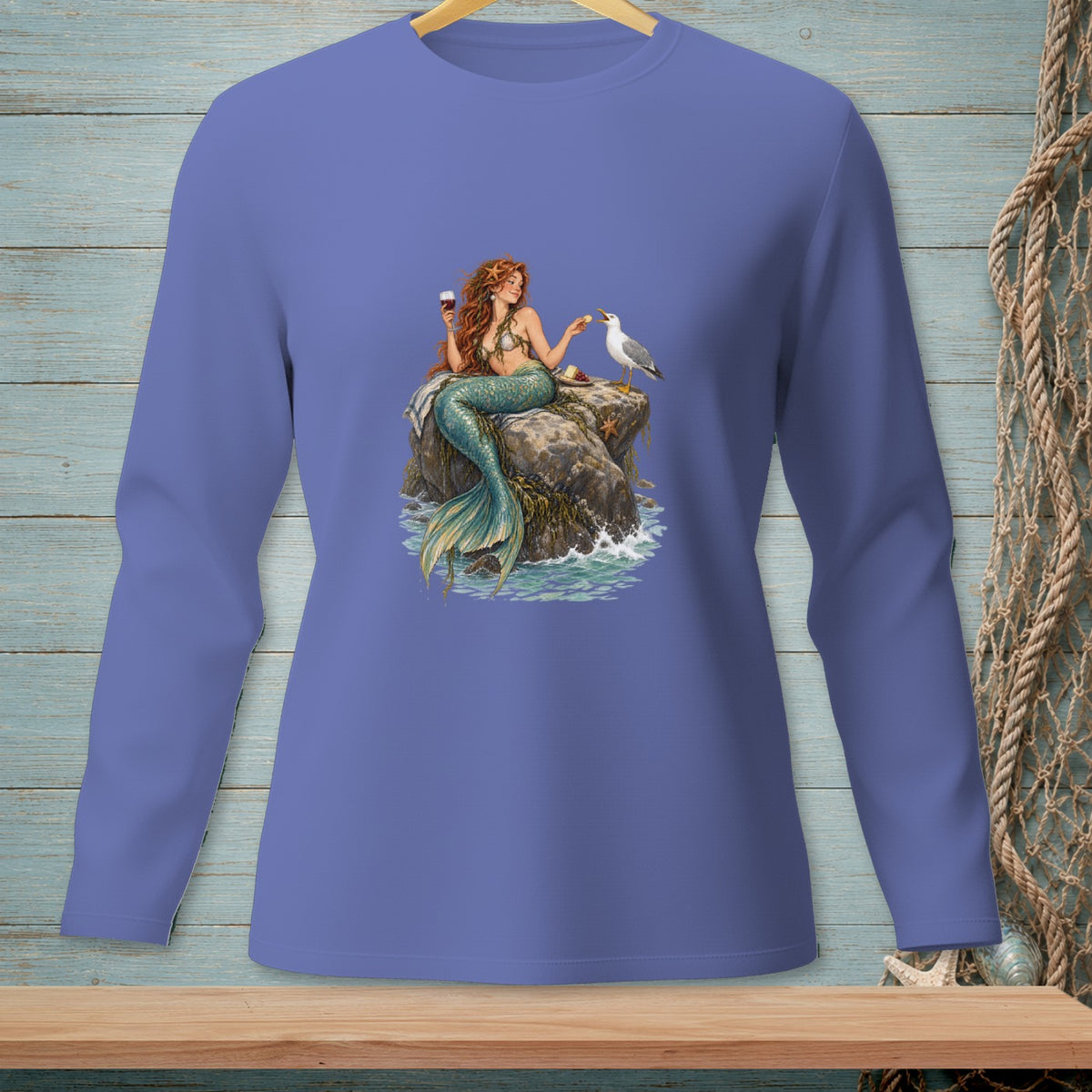 Illustration of a mermaid holding wine, sharing food with a seagull on a rock.