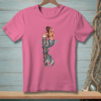 Pink t-shirt with illustration of a mermaid wrapped around a wooden post, drinking from a glass.