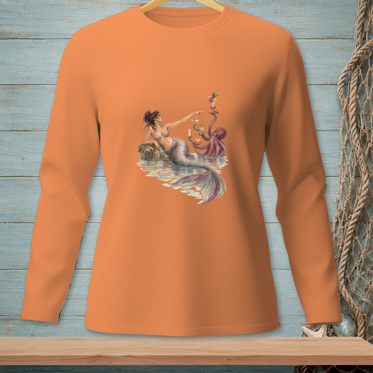 Orange long-sleeve shirt with a watercolor design of a mermaid and an octopus.