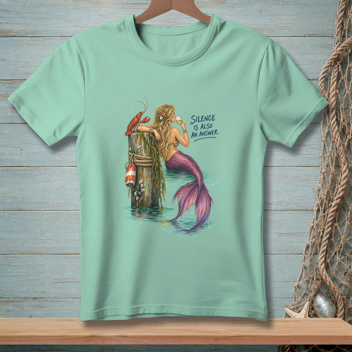 Mermaid with lobster on a dock drinks wine with text "SILENCE IS ALSO AN ANSWER."
