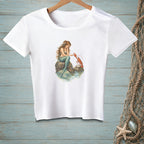 White t-shirt with mermaid and lobster artwork on a rock in water.